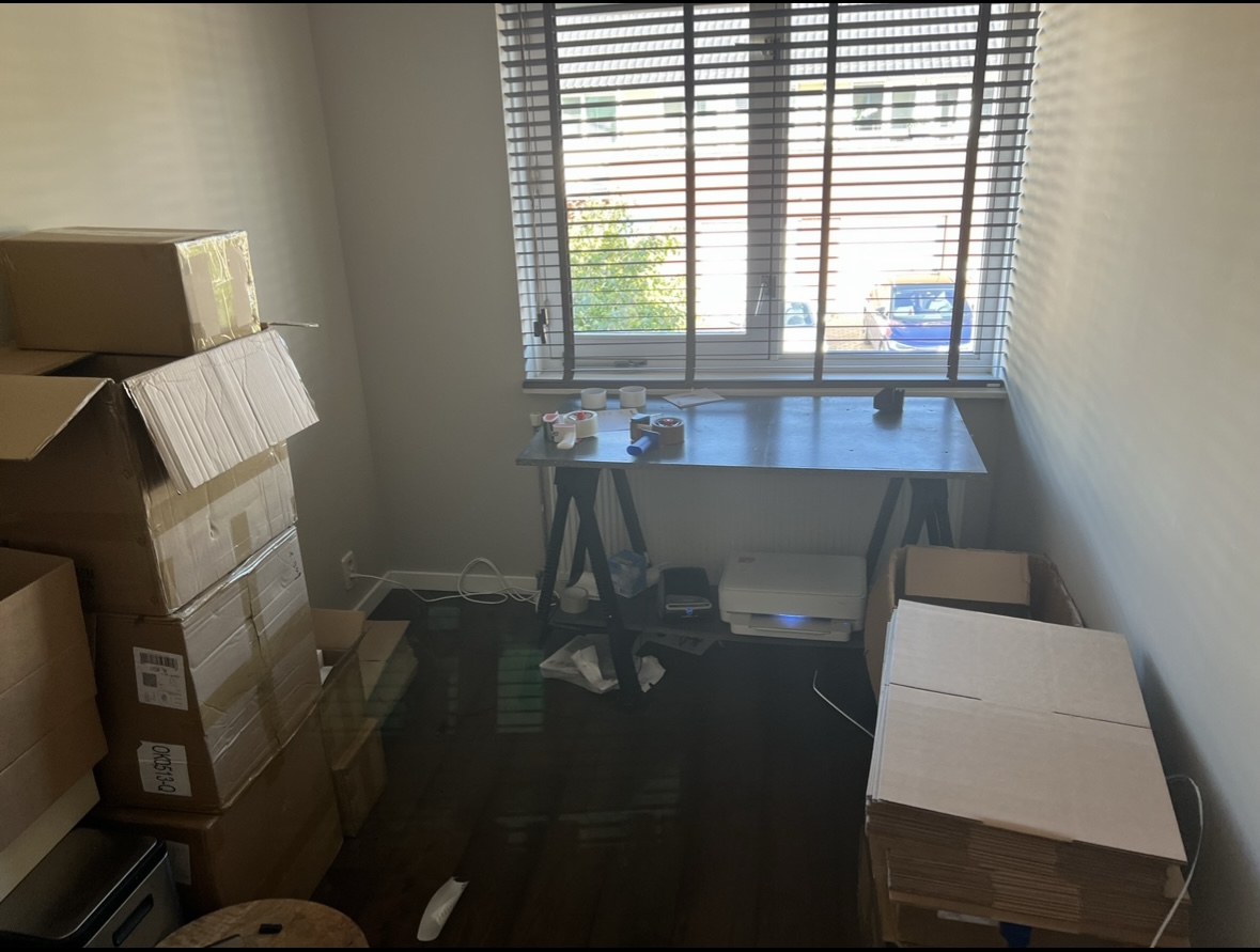 The first home workroom, a table, a printer and the first boxes ready to ship
